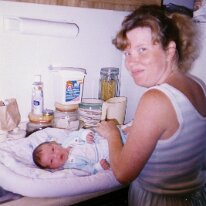 Becky changing baby Caitlin